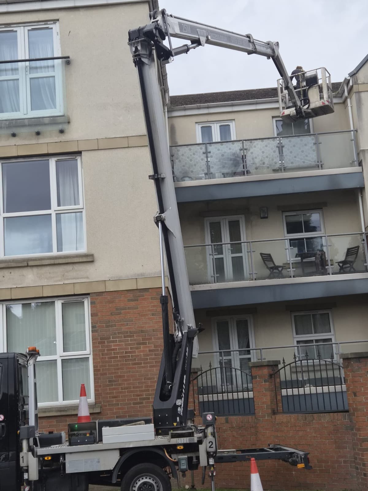 Cherry picker access platform reaching a flat roof for repair work